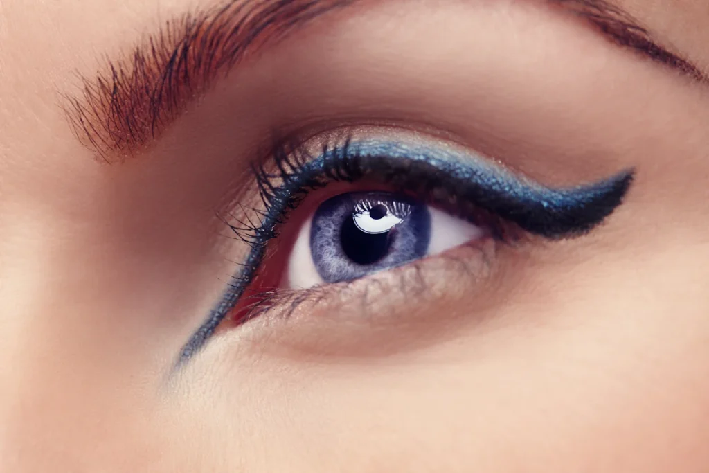 L'oeil d'une femme avec un beau maquillage et un trait d'aye liner noir précis