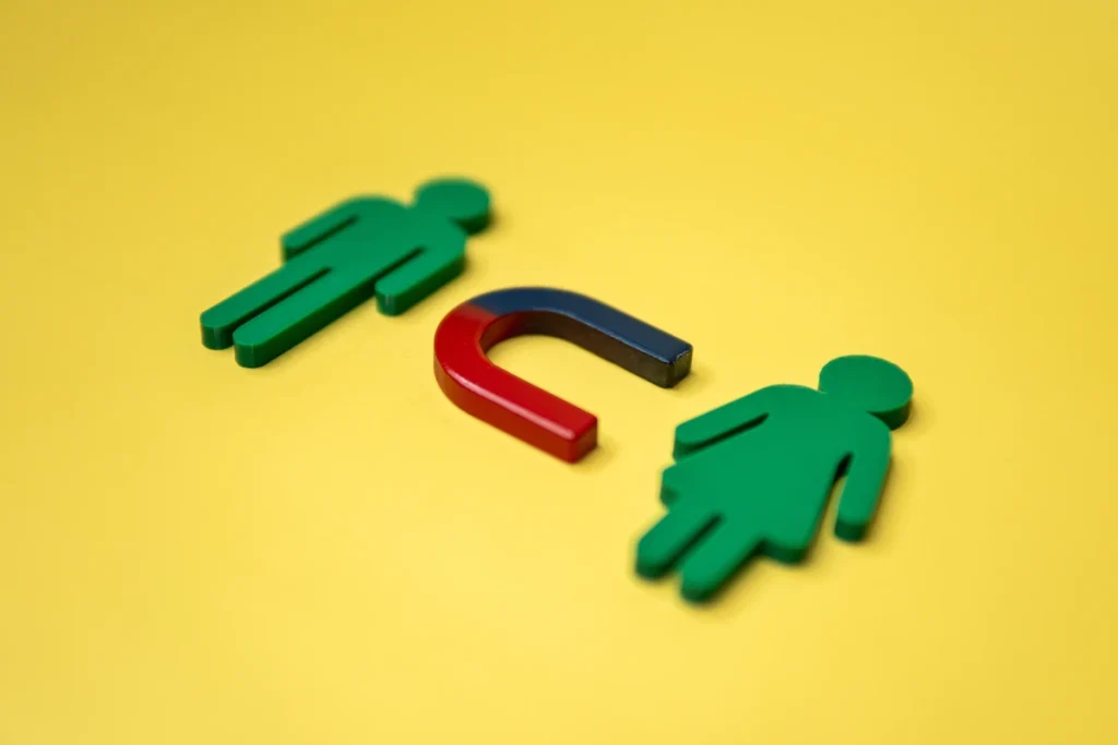 Deux personnages verts avec un aimant au milieu