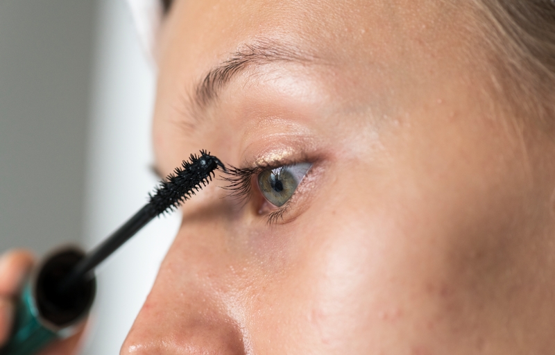 femme qui met du mascara